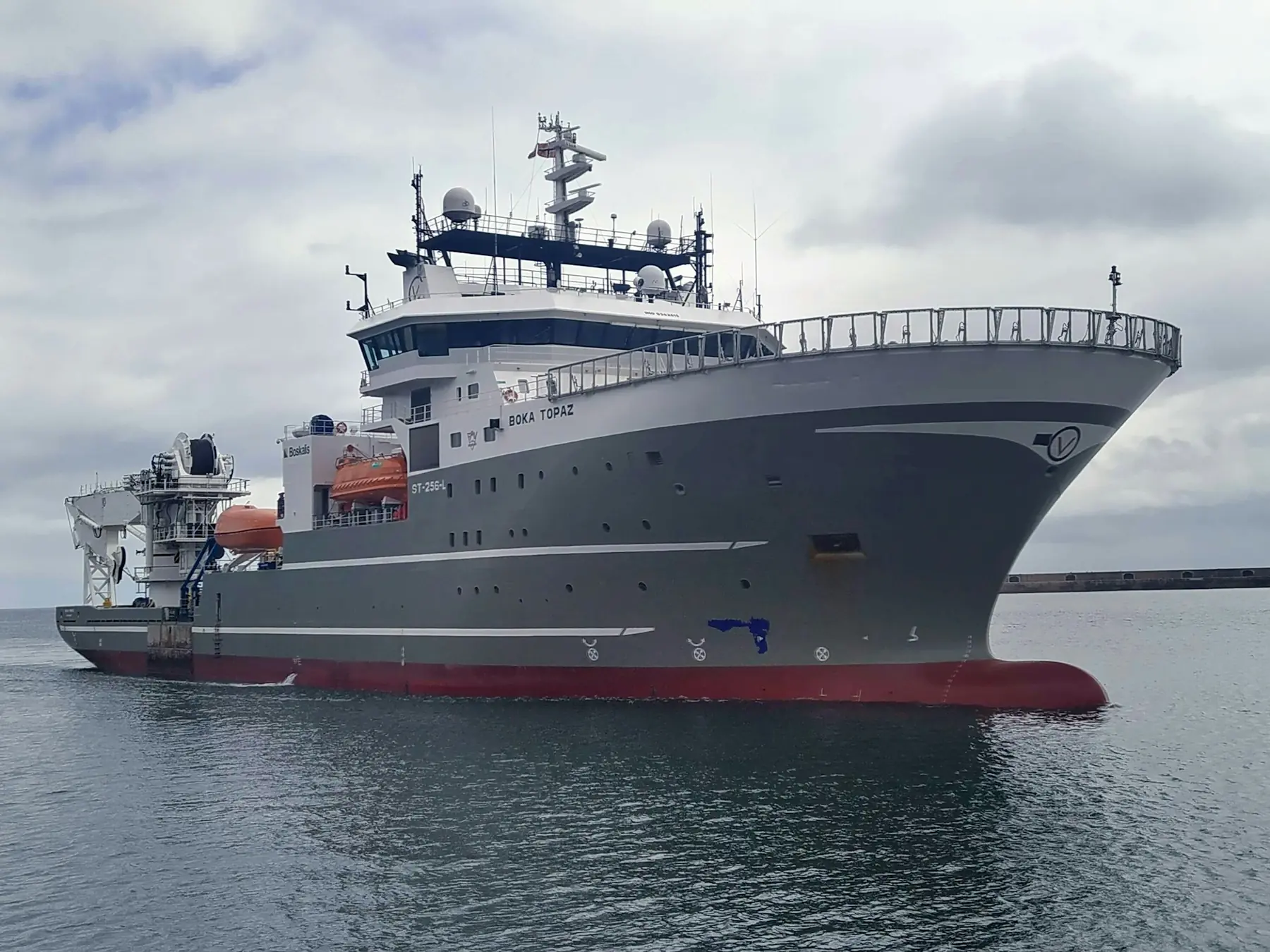 An offshore support vessel alongside a quay